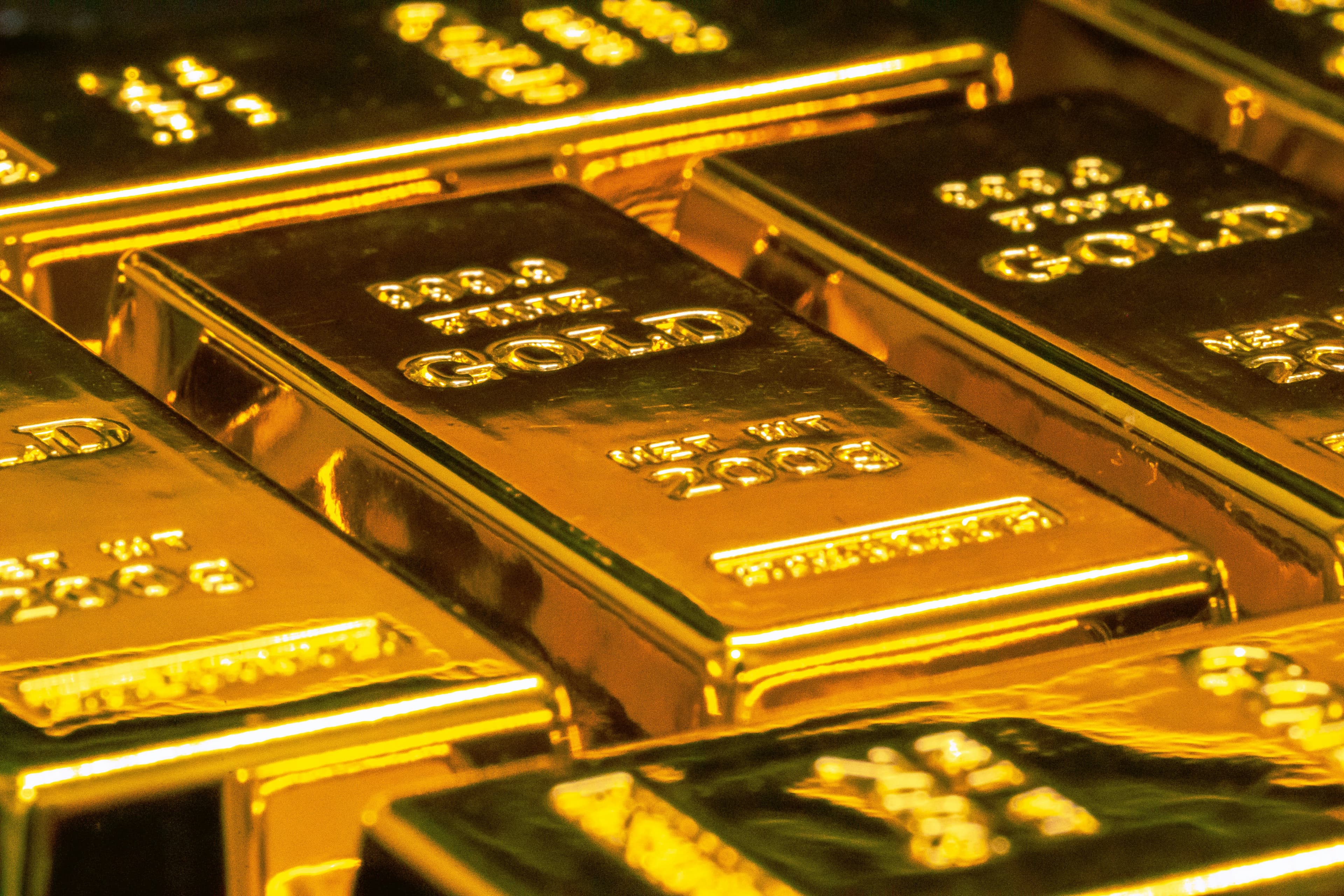 Gold bars representing safe-haven commodity demand during geopolitical uncertainty